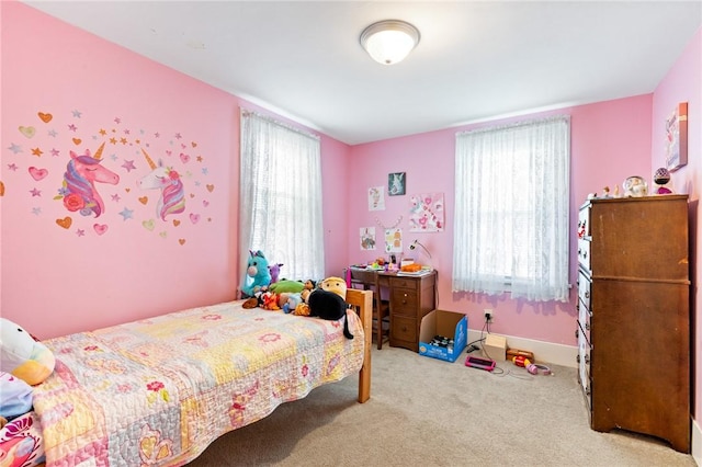 carpeted bedroom with multiple windows