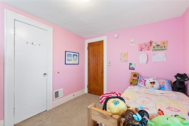 bedroom featuring baseboards, visible vents, and carpet