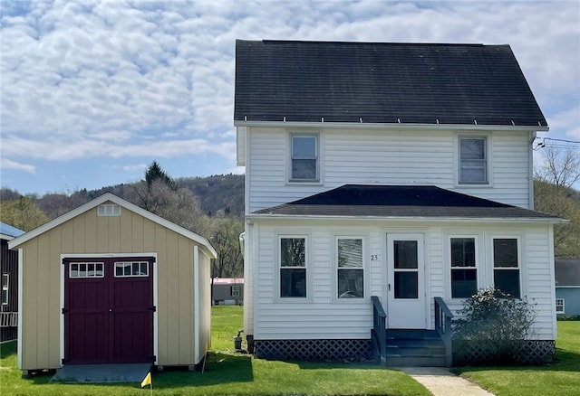 25 W Greenwood St, Andover, NY 14806 - rear view of house featuring a yard, an outdoor structure, a shed, and entry steps