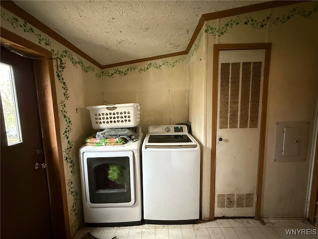 laundry area featuring laundry area, ornamental molding, washer and dryer, wallpapered walls, and a textured ceiling