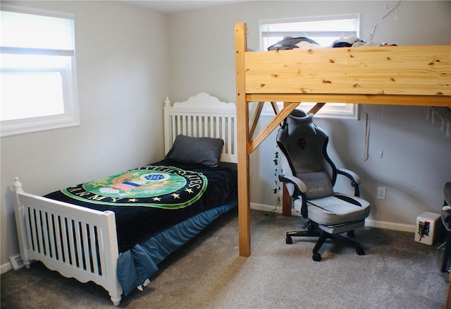 bedroom featuring baseboards and carpet