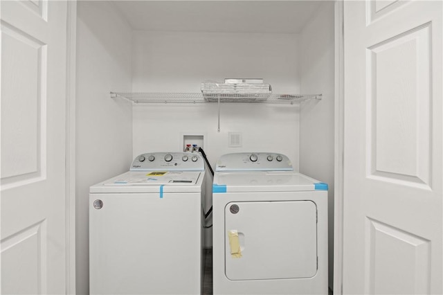 clothes washing area featuring laundry area and washer and dryer