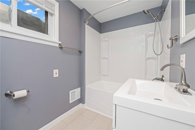 bathroom with visible vents, bathing tub / shower combination, baseboards, tile patterned floors, and a sink