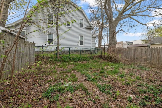 exterior space with fence and a gambrel roof
