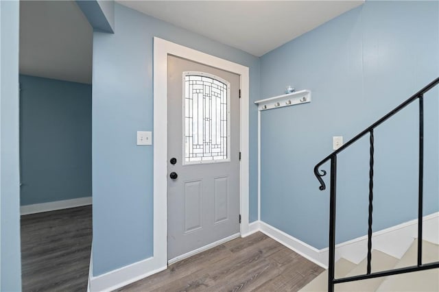 entryway featuring baseboards and wood finished floors