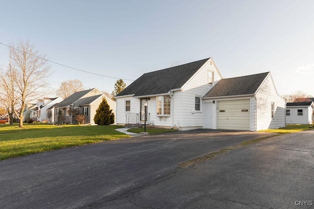 314 Westlind Rd, Geddes, NY 13219 - view of front facade with a residential view, driveway, a shingled roof, and a front yard