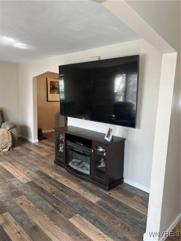 living area featuring baseboards and wood finished floors