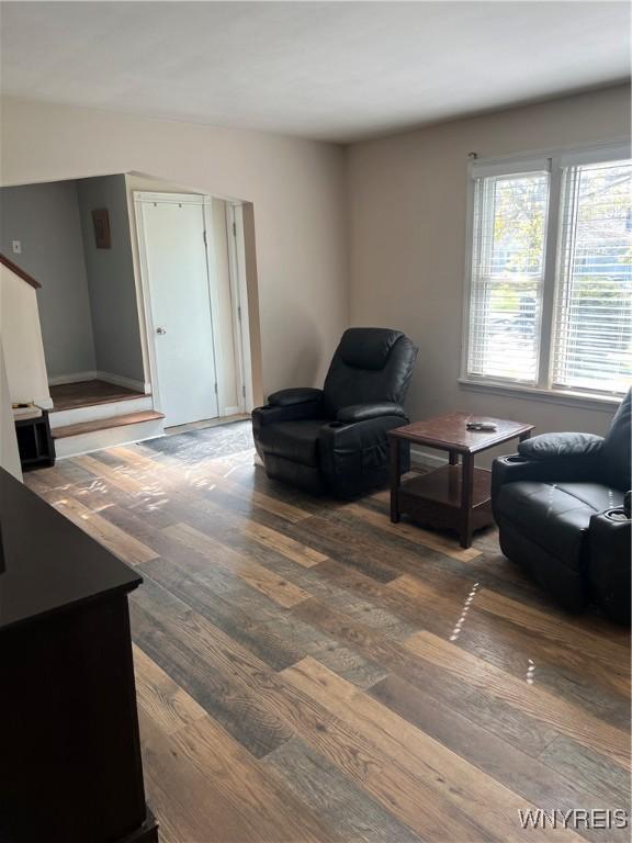 living room featuring stairs and wood finished floors