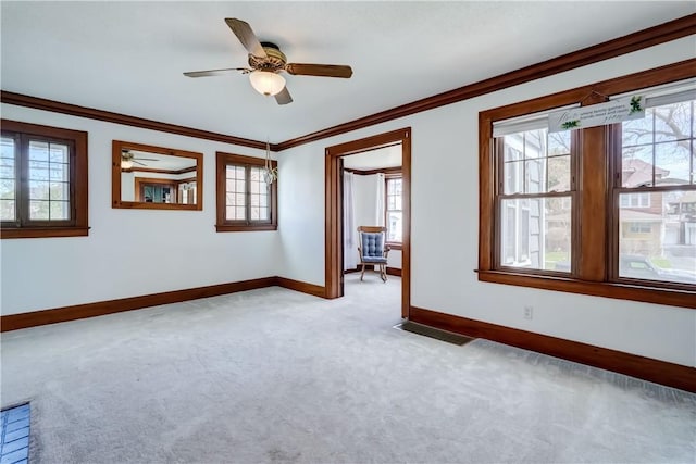 unfurnished room with baseboards, light carpet, and a wealth of natural light