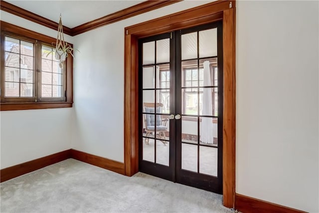 doorway featuring french doors, ornamental molding, baseboards, and carpet flooring