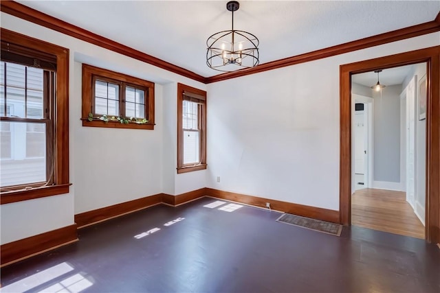 spare room with an inviting chandelier, ornamental molding, and baseboards