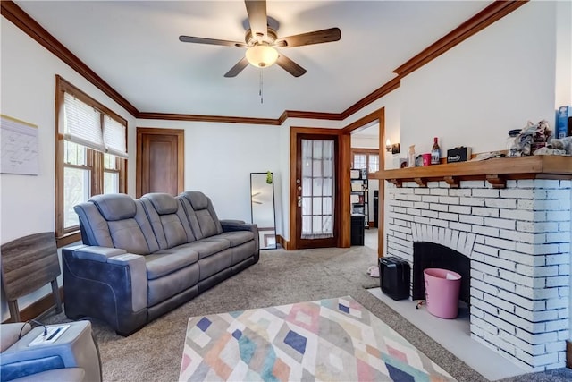 carpeted living room with baseboards, ornamental molding, ceiling fan, and a fireplace