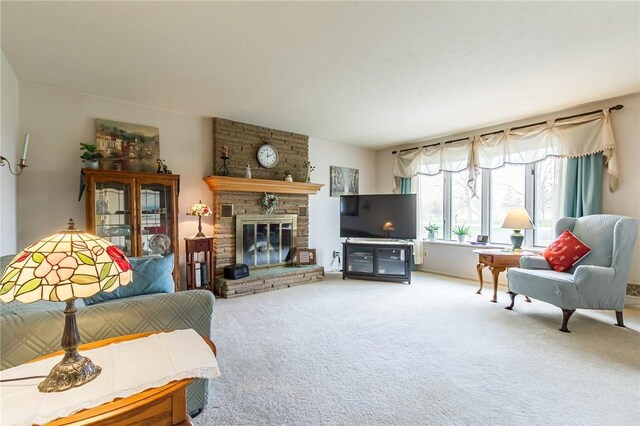 living area with a large fireplace and carpet flooring