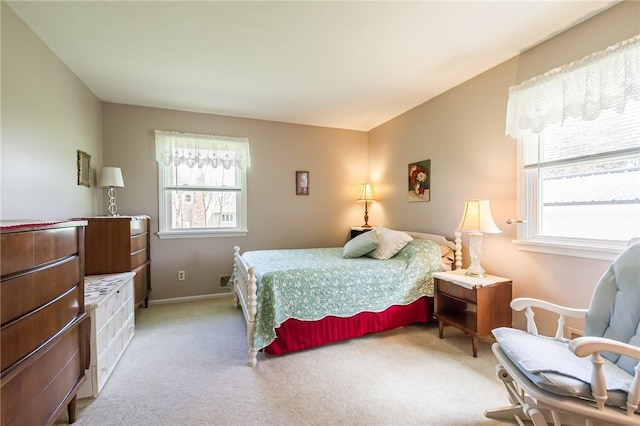 bedroom with baseboards and light carpet