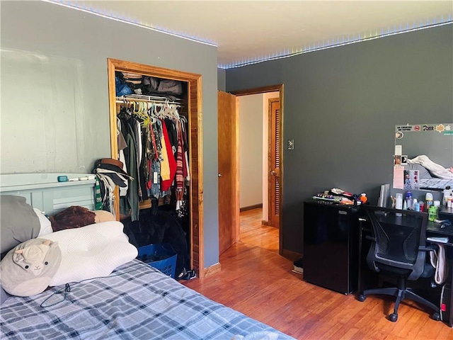 5291 Starr Rd, Thurston, NY 14821 - bedroom featuring fridge, wood finished floors, and a closet