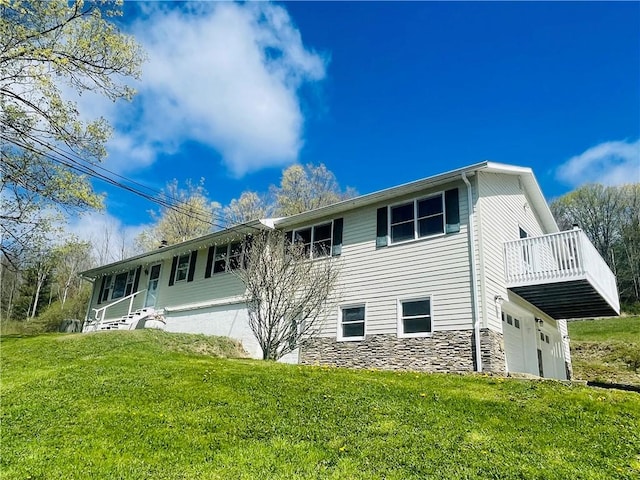 5291 Starr Rd, Thurston, NY 14821 - rear view of house featuring a lawn, an attached garage, and stone siding