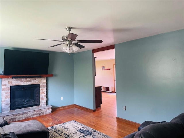 5291 Starr Rd, Thurston, NY 14821 - living room with baseboards, ceiling fan, wood finished floors, and a fireplace