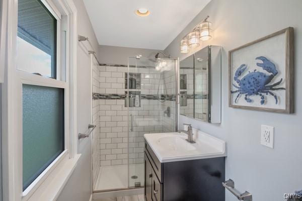 full bath featuring vanity and a shower stall