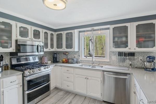 kitchen featuring a sink, white cabinetry, appliances with stainless steel finishes, and light countertops