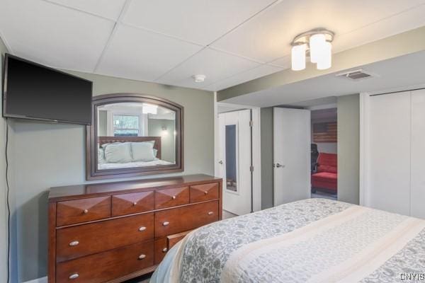 bedroom featuring visible vents and a drop ceiling