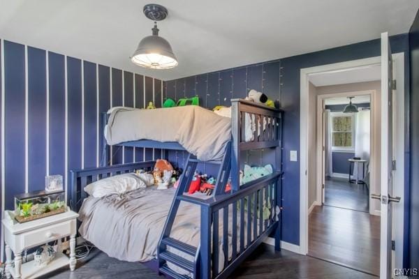 bedroom with baseboards and wood finished floors