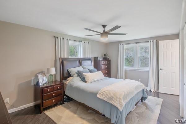 bedroom featuring baseboards, ceiling fan, and wood finished floors