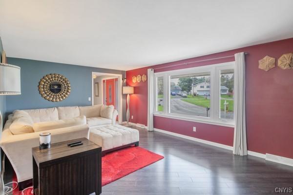 living room featuring baseboards and wood finished floors