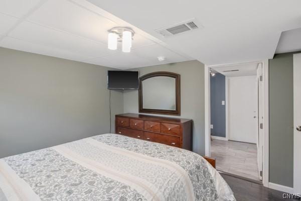 bedroom with baseboards, visible vents, and a closet