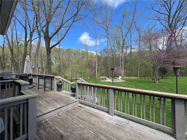 wooden deck with a lawn