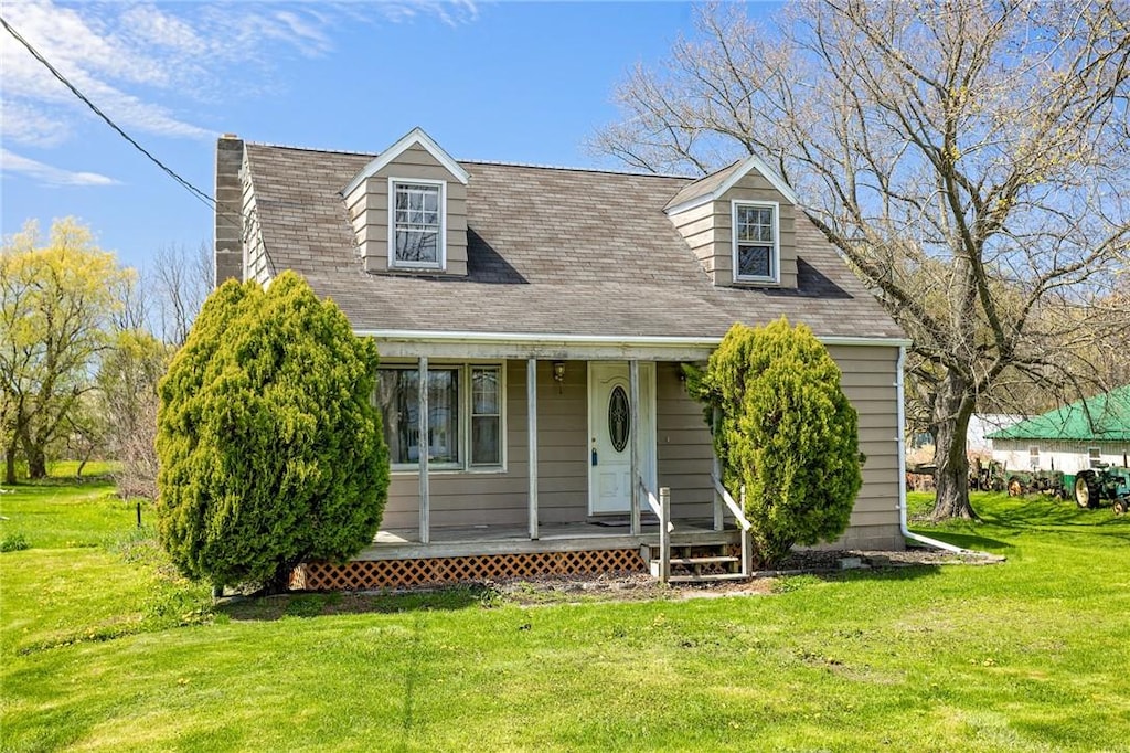 6972 Cole Rd, Leroy, NY 14482 - cape cod-style house featuring a porch, a shingled roof, and a front yard