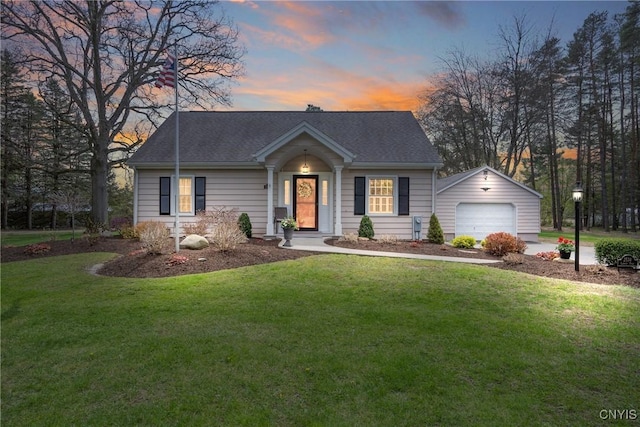 view of front of property with a garage, a yard, driveway, and roof with shingles