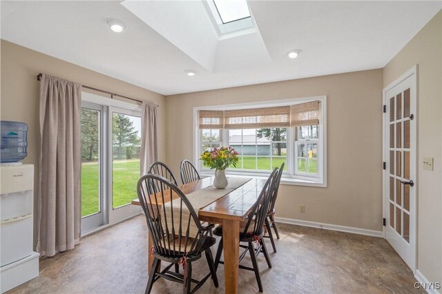 dining area with baseboards, recessed lighting, and a skylight