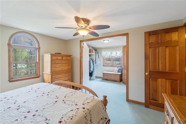 bedroom featuring baseboards, a ceiling fan, and light colored carpet