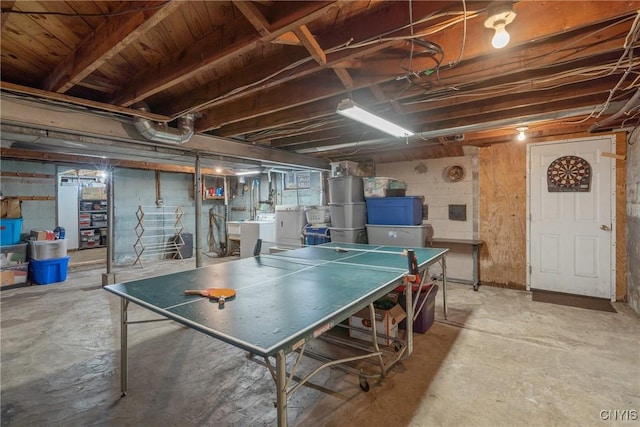 recreation room featuring concrete floors and washer and dryer