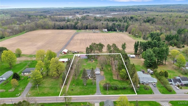 birds eye view of property with a forest view and a rural view