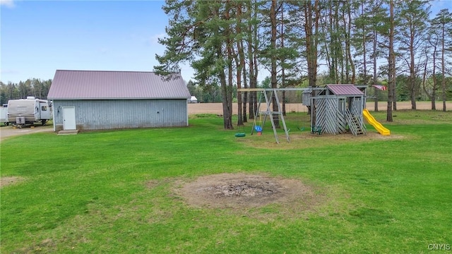 view of yard with a playground, an outbuilding, and an outdoor structure