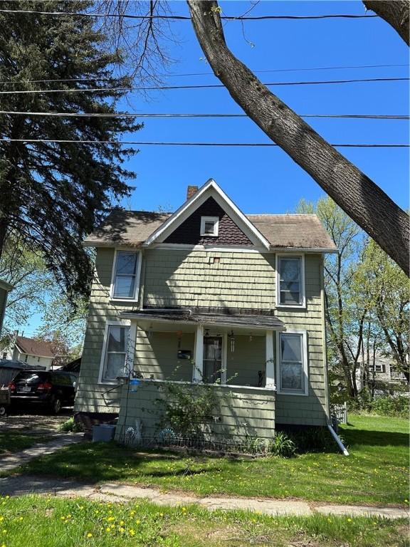 307 Sylvester Pl, Elmira-City, NY 14904 - view of front of home featuring a porch, a chimney, and a front yard