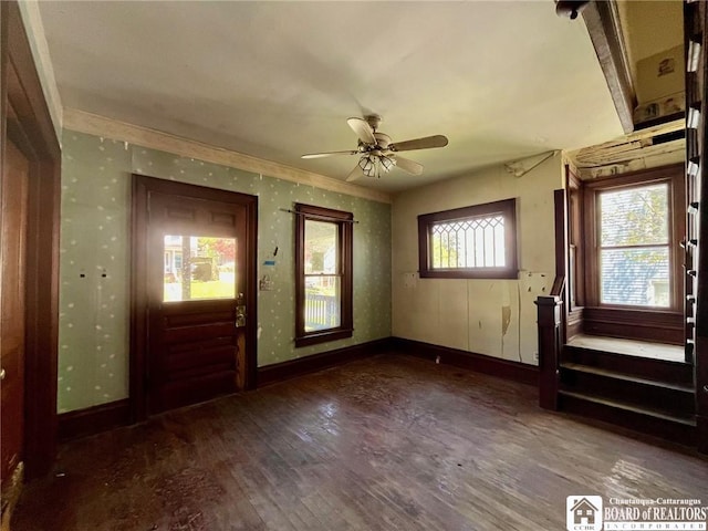 foyer featuring baseboards, ceiling fan, and wood finished floors