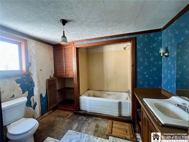 full bath with vanity, wood finished floors, toilet, a textured ceiling, and a bath