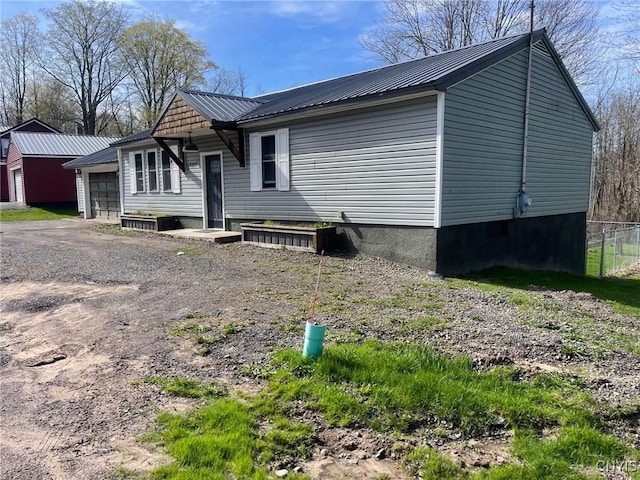 3217 County Route 4, Volney, NY 13069 - exterior space with fence, metal roof, and a garage