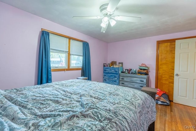bedroom with ceiling fan and wood finished floors