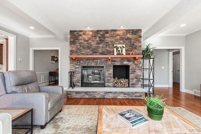 3830 Rippleton Rd, Cazenovia, NY 13035 - living room with crown molding, beam ceiling, a stone fireplace, wood finished floors, and visible vents