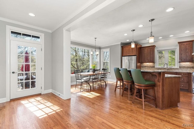 3830 Rippleton Rd, Cazenovia, NY 13035 - kitchen featuring baseboards, plenty of natural light, freestanding refrigerator, and a breakfast bar area