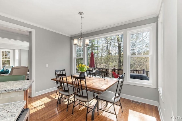 3830 Rippleton Rd, Cazenovia, NY 13035 - dining space featuring crown molding, baseboards, light wood-type flooring, and visible vents