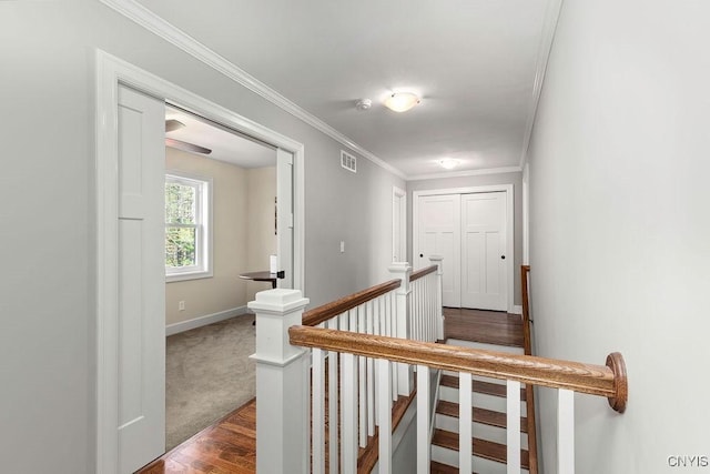 3830 Rippleton Rd, Cazenovia, NY 13035 - corridor featuring dark wood finished floors, baseboards, an upstairs landing, visible vents, and ornamental molding