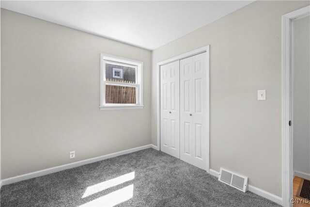 407 Montrose Ave, Geddes, NY 13219 - unfurnished bedroom with baseboards, carpet, a closet, and visible vents