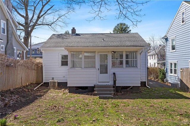 407 Montrose Ave, Geddes, NY 13219 - back of house featuring a chimney, roof with shingles, fence, a yard, and entry steps