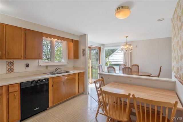 kitchen featuring a sink, light floors, dishwasher, and a wealth of natural light