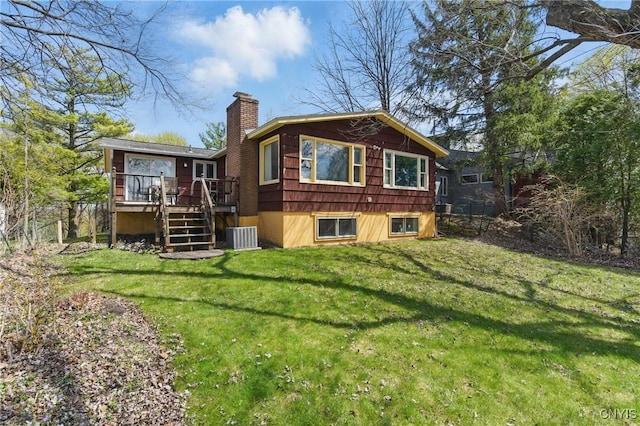 rear view of house with stairs, central air condition unit, a wooden deck, a chimney, and a lawn