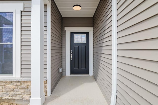 property entrance with stone siding